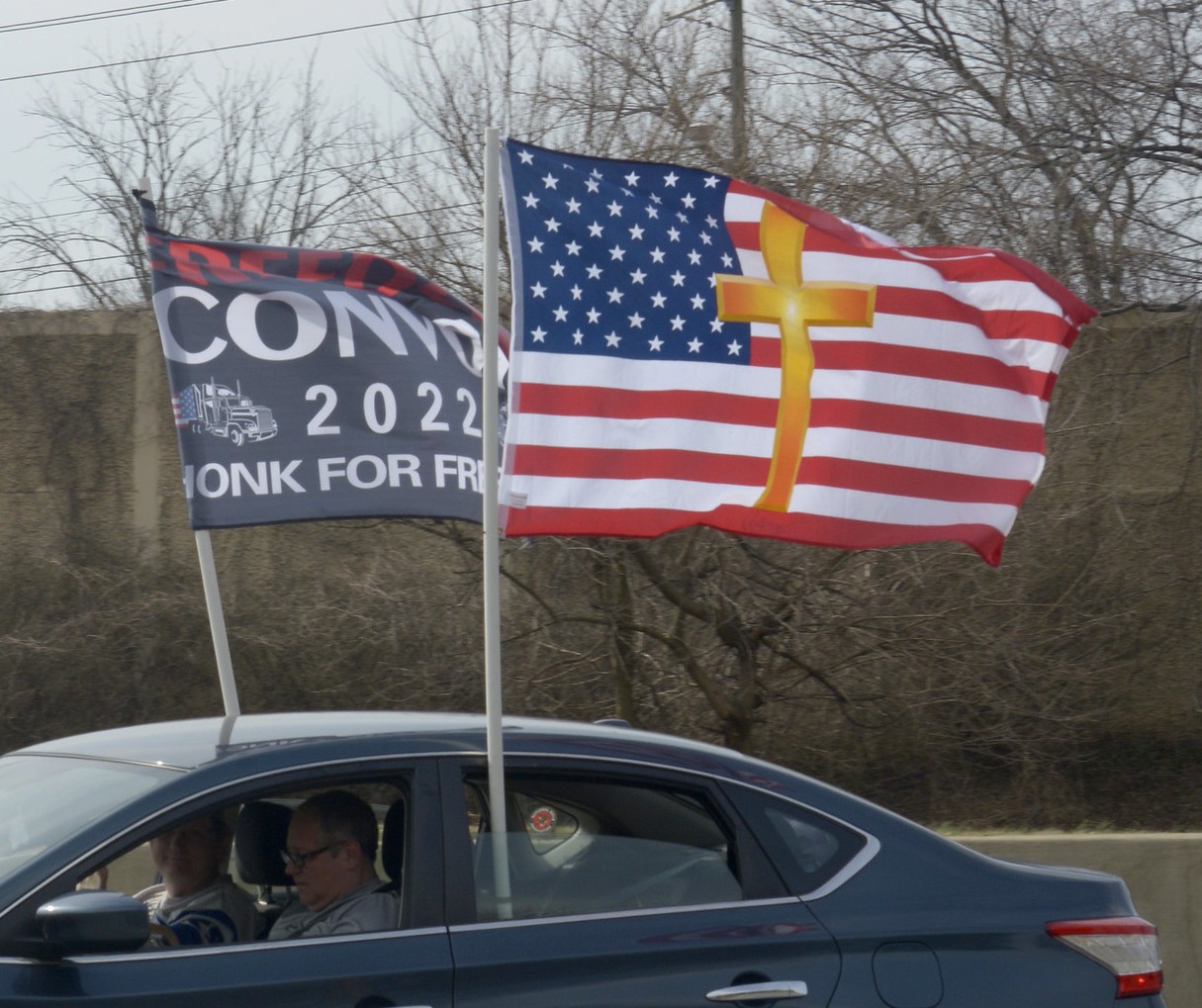 A US flag with a Christian cross drawn over it